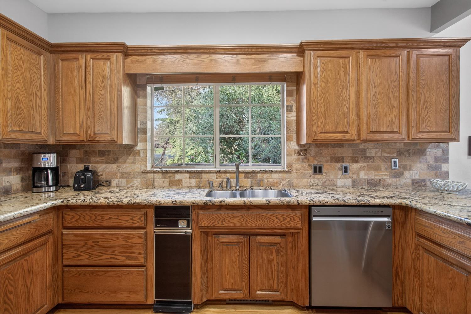 8681 Winding Way Fair Oaks, CA 95628 - Photo 22 of 87 a kitchen with granite countertop stainless steel appliances white cabinets sink and window