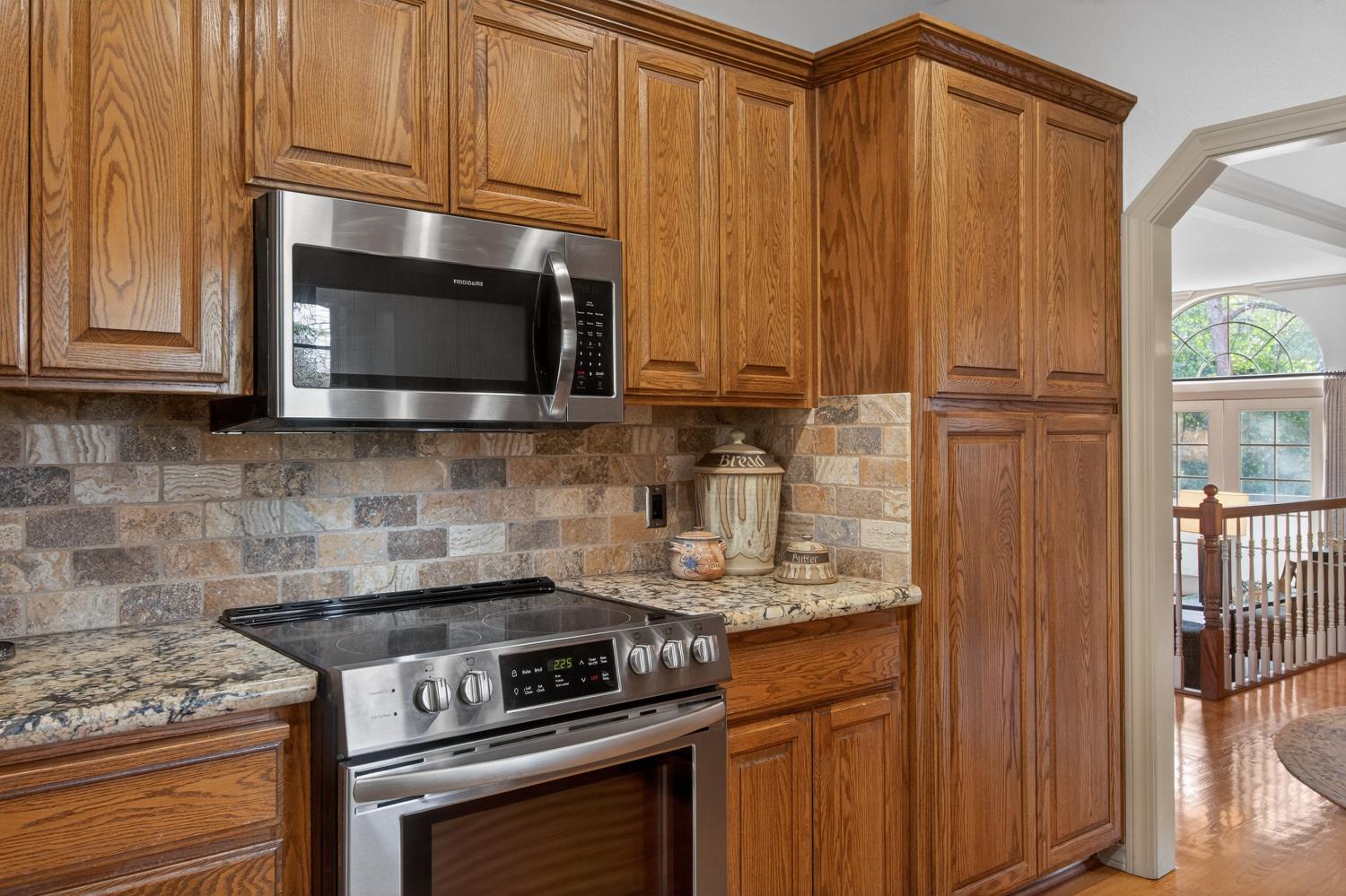 8681 Winding Way Fair Oaks, CA 95628 - Photo 24 of 87 a kitchen with stainless steel appliances granite countertop a stove microwave and cabinets