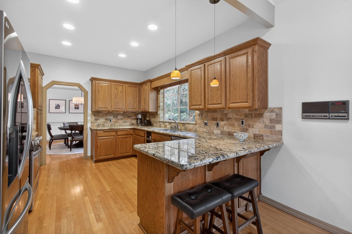 8681 Winding Way Fair Oaks, CA 95628 - Photo 25 of 87 a kitchen with stainless steel appliances granite countertop a stove a sink dishwasher and a refrigerator with wooden floor