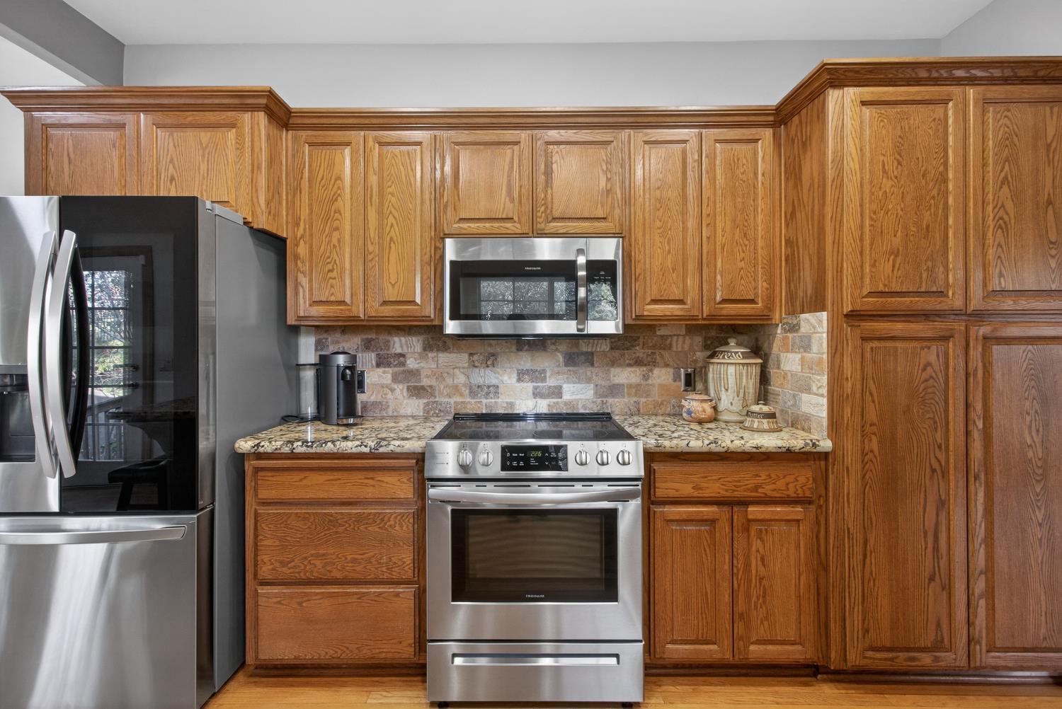 8681 Winding Way Fair Oaks, CA 95628 - Photo 26 of 87 a kitchen with granite countertop wooden cabinets and stainless steel appliances