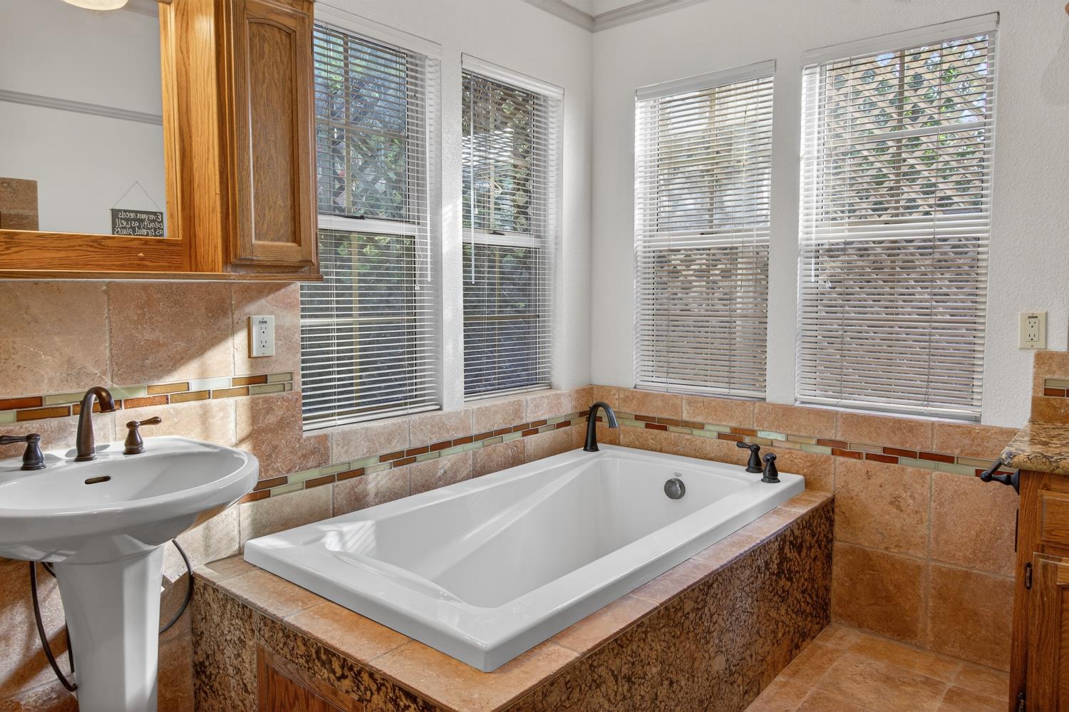 8681 Winding Way Fair Oaks, CA 95628 - Photo 36 of 87 a bath tub sitting in a bathroom next to a window