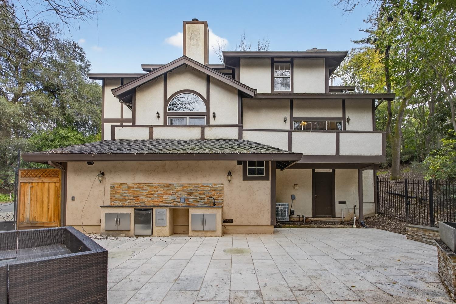 8681 Winding Way Fair Oaks, CA 95628 - Photo 80 of 87 a view of a white house with large windows and a table and chairs
