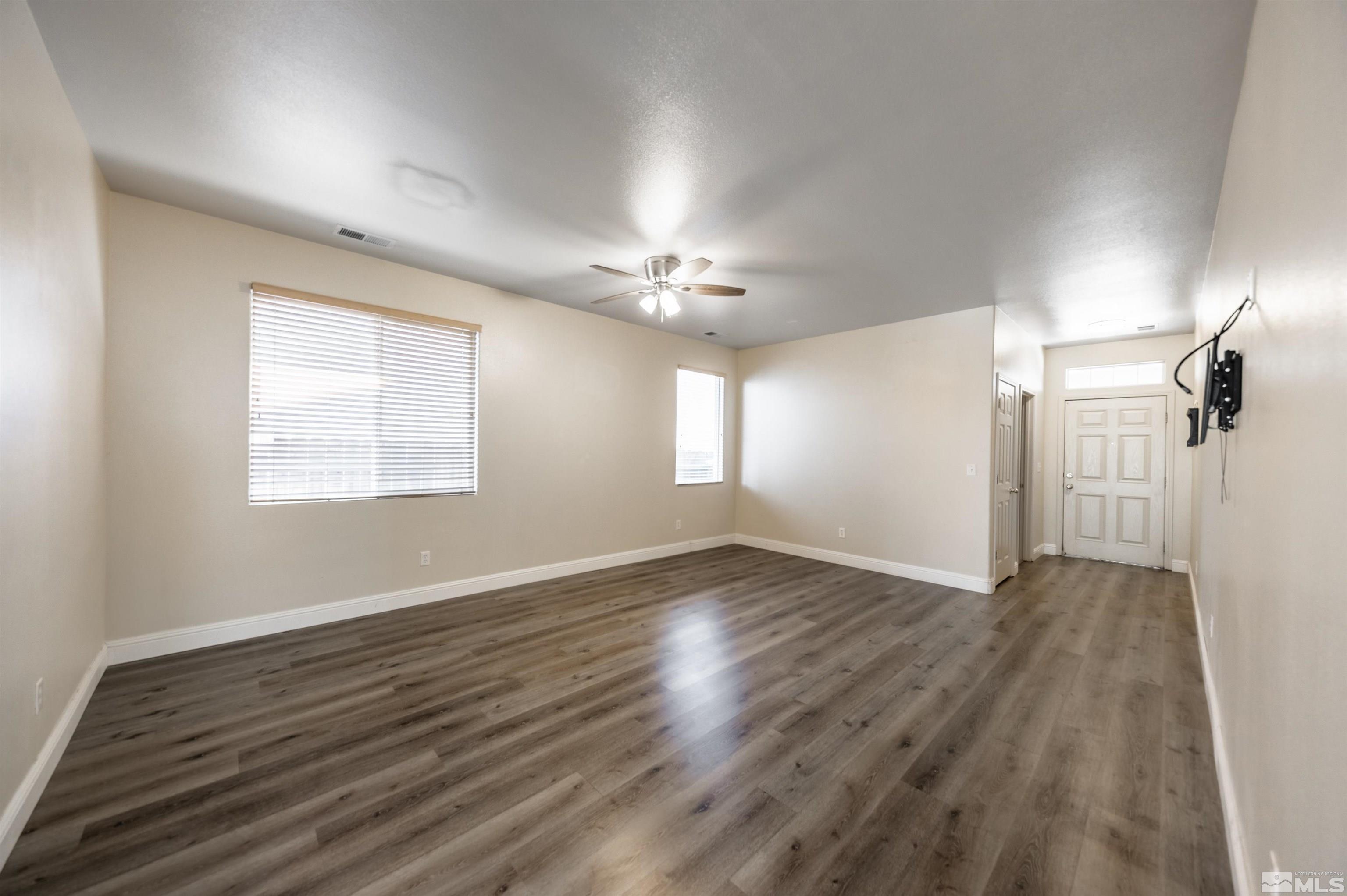2260 Big Trail Circle Reno, NV 89521 - Photo 6 of 29 a view of an empty room with wooden floor and a window