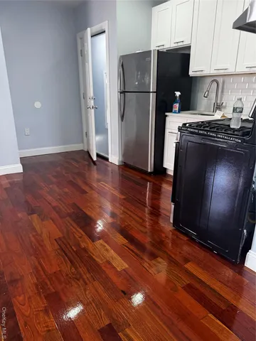 a kitchen with a refrigerator and a stove