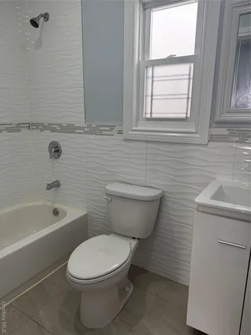 a bathroom with a toilet a sink and bathtub