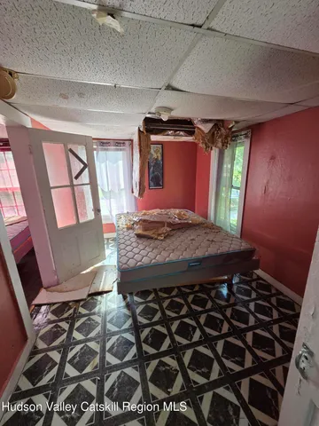 a bed sitting in a bedroom next to a window