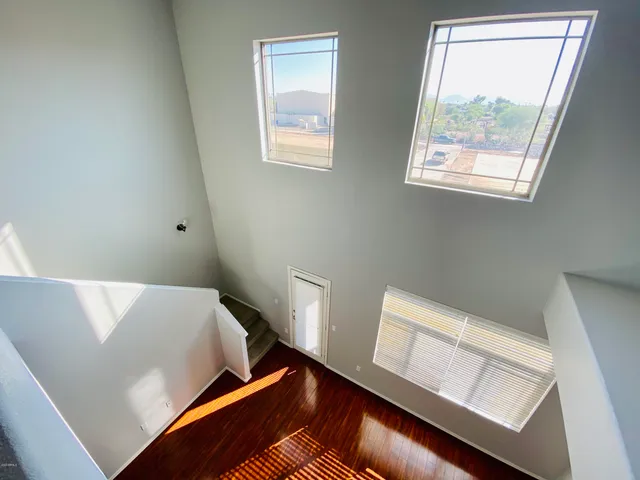 a view of room with window and wooden floor