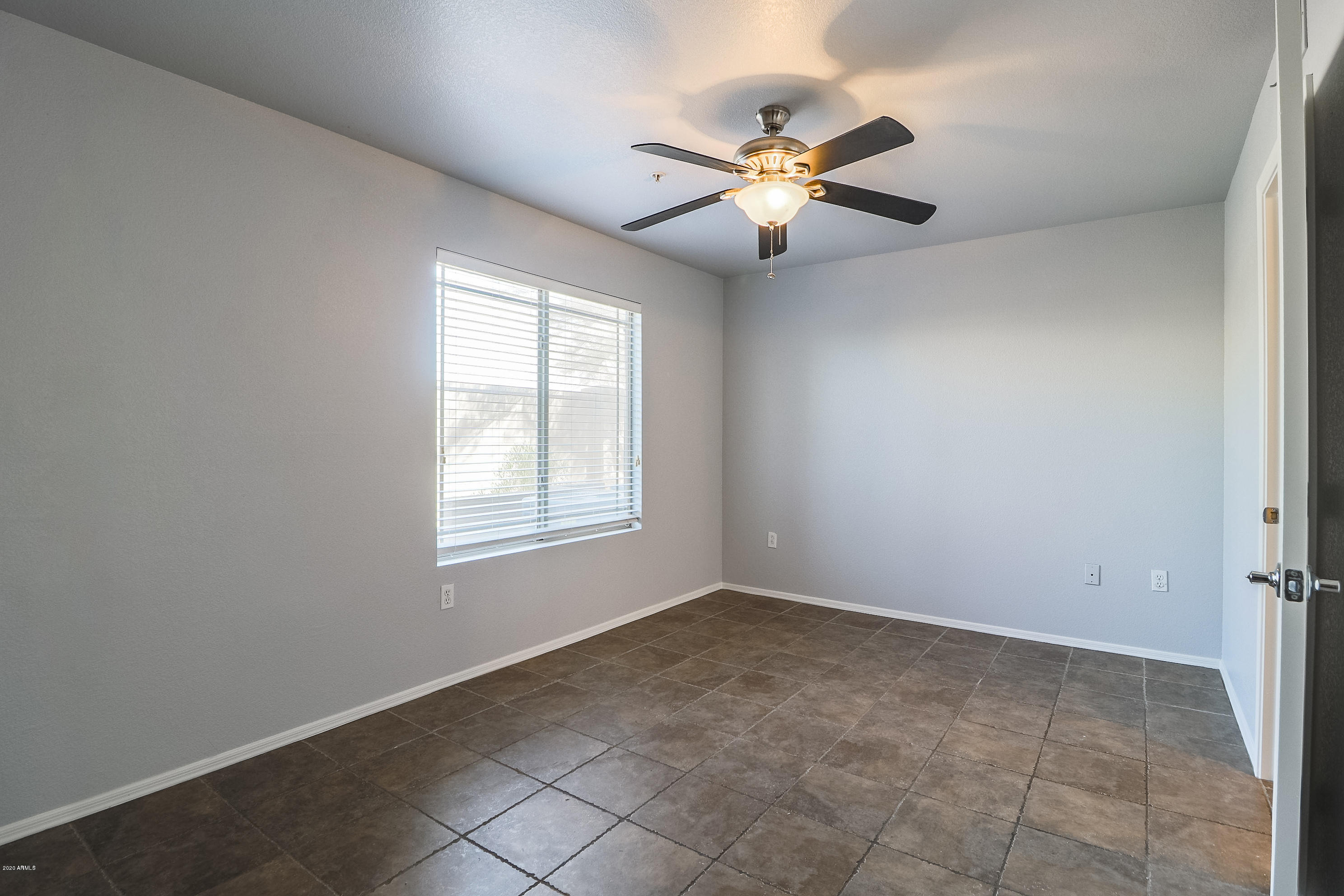 16825 North 14th Street, Unit 45 Phoenix, AZ 85022 - Photo 12 of 35 an empty room with windows and chandelier fan
