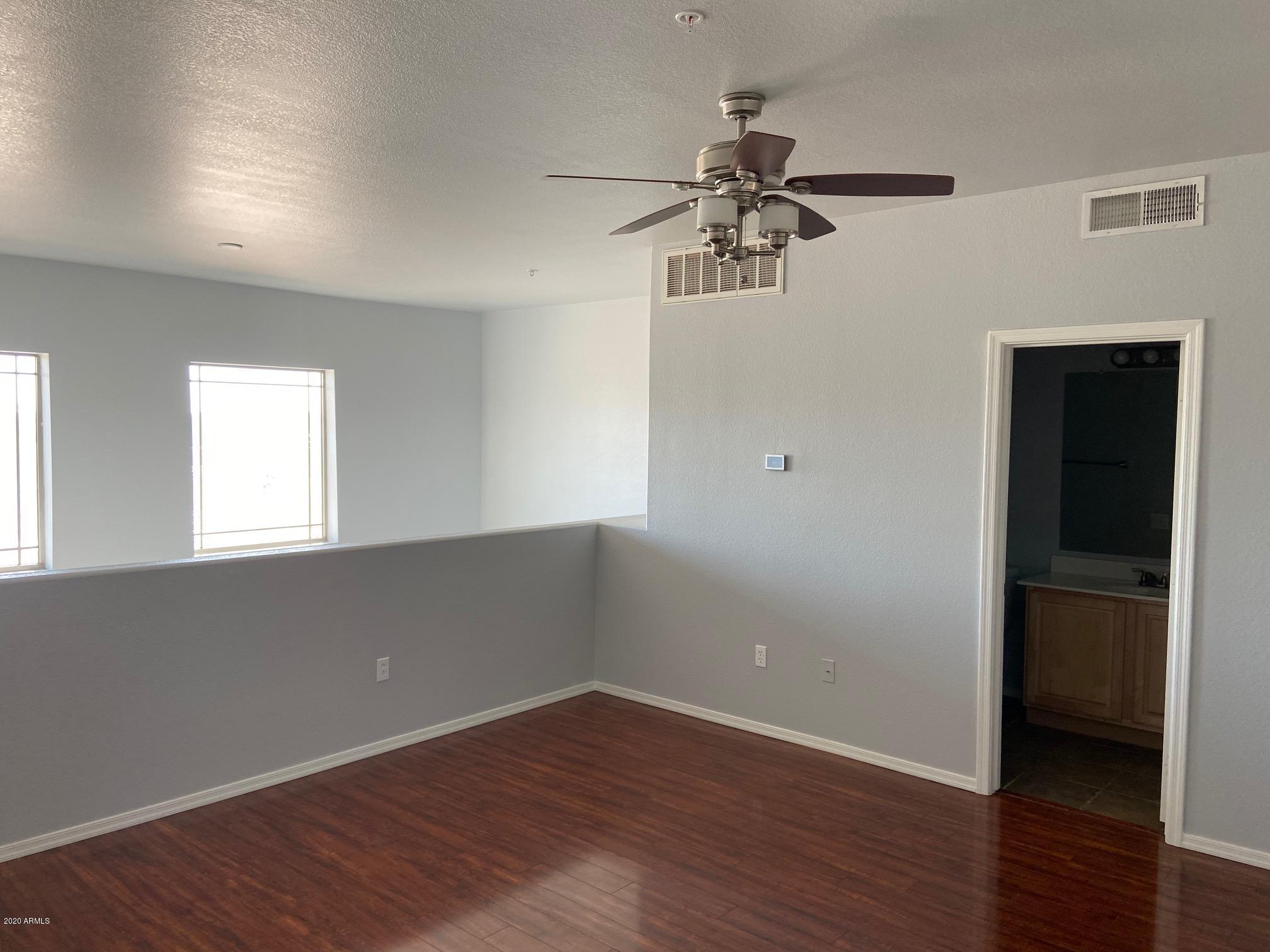 16825 North 14th Street, Unit 45 Phoenix, AZ 85022 - Photo 20 of 35 wooden floor in an empty room with a window