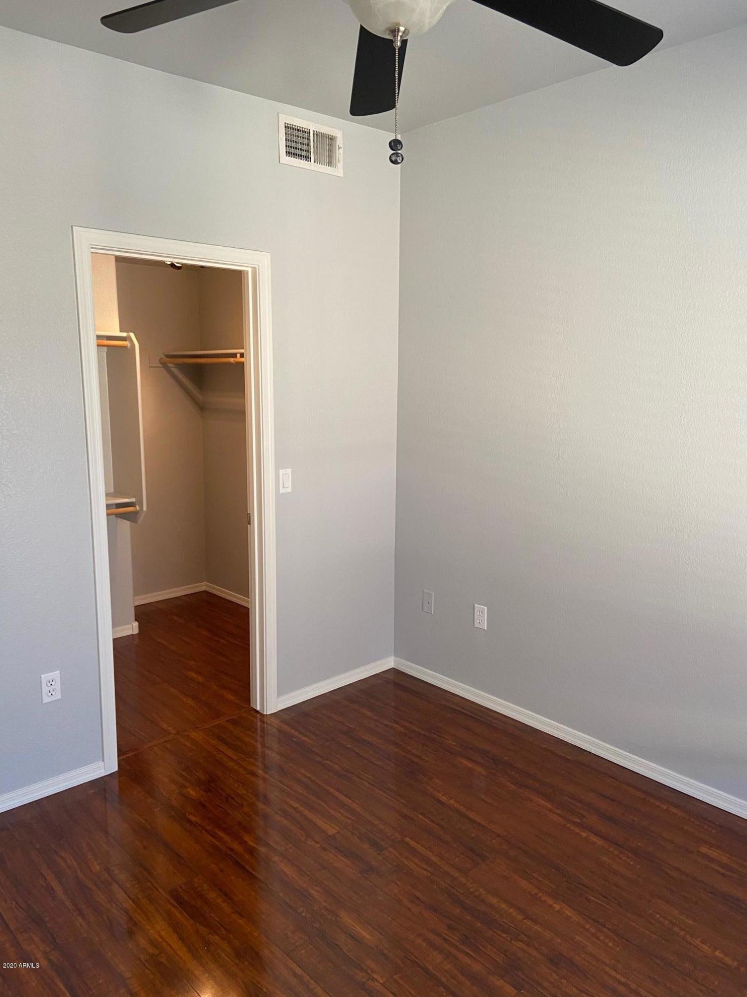 16825 North 14th Street, Unit 45 Phoenix, AZ 85022 - Photo 21 of 35 a view of a room with wooden floor and closet