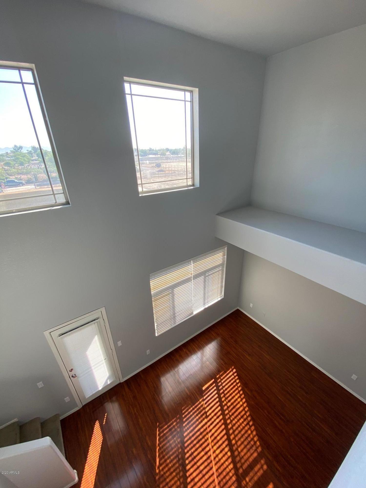 16825 North 14th Street, Unit 45 Phoenix, AZ 85022 - Photo 27 of 35 a view of an empty room with wooden floor and a window