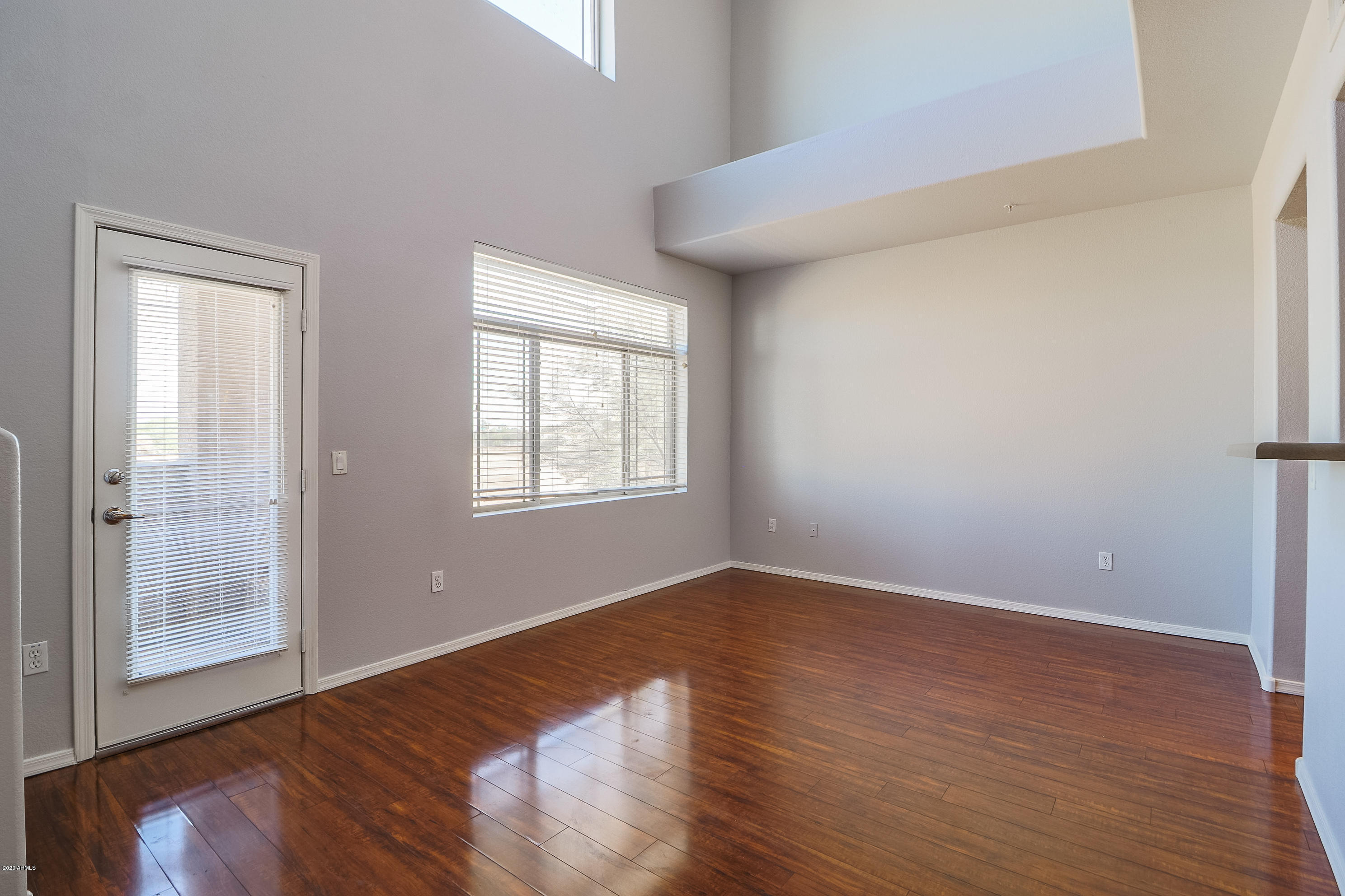 16825 North 14th Street, Unit 45 Phoenix, AZ 85022 - Photo 3 of 35 a view of an empty room with wooden floor and a window