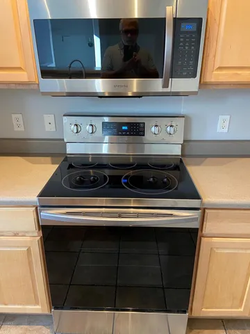 a stove top oven sitting inside of a kitchen