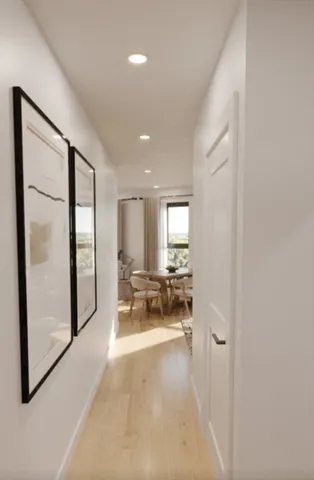 a view of a hallway with couch and a chandelier