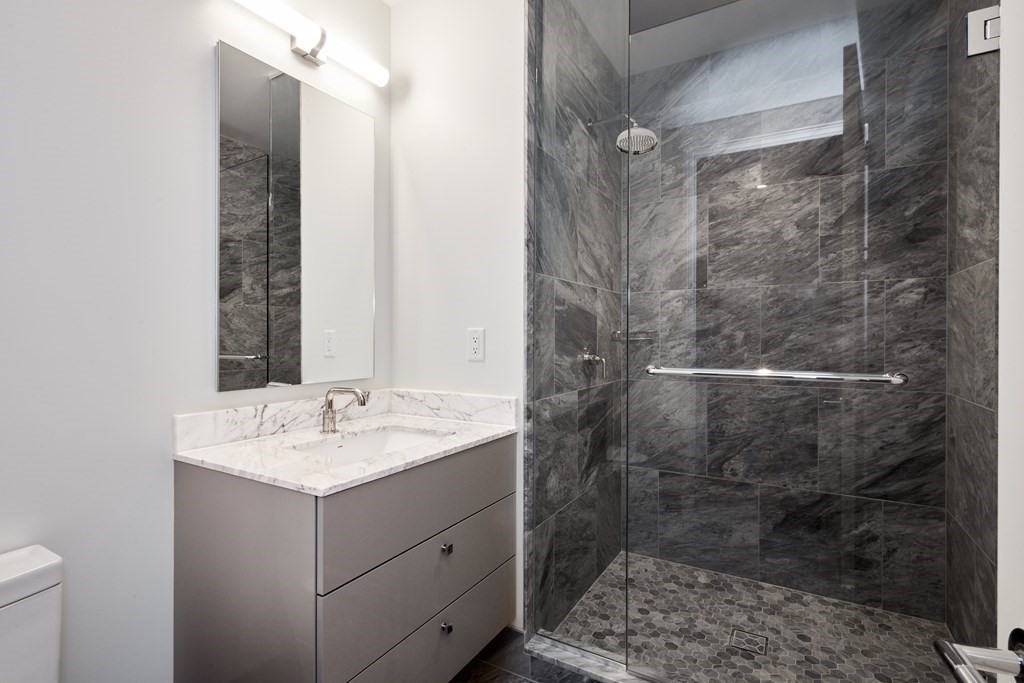 240 Devonshire Street, Unit 4210 Boston, MA 02110 - Photo 9 of 39 a bathroom with a sink and mirror