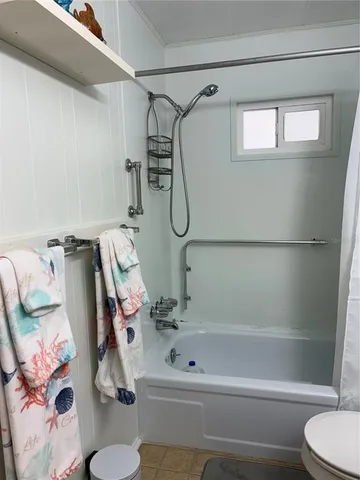 a bathroom with a tub and a shower