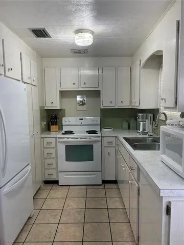 a kitchen with cabinets stainless steel appliances and a counter space