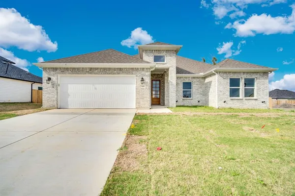 a front view of a house with a yard
