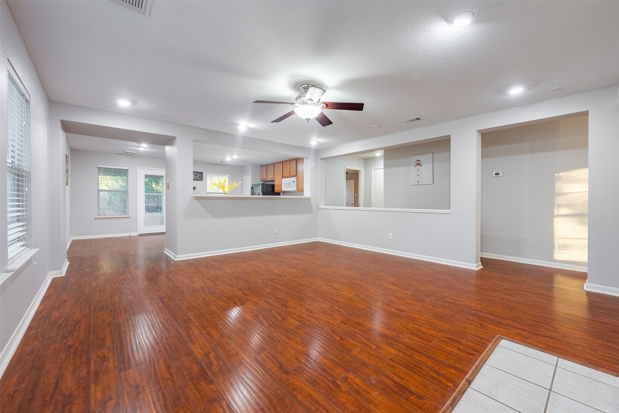 15823 Kings Cypress Lane Cypress, TX 77429 - Photo 13 of 33 Bright and open concept family room featuring beautiful wood laminate flooring throughout.