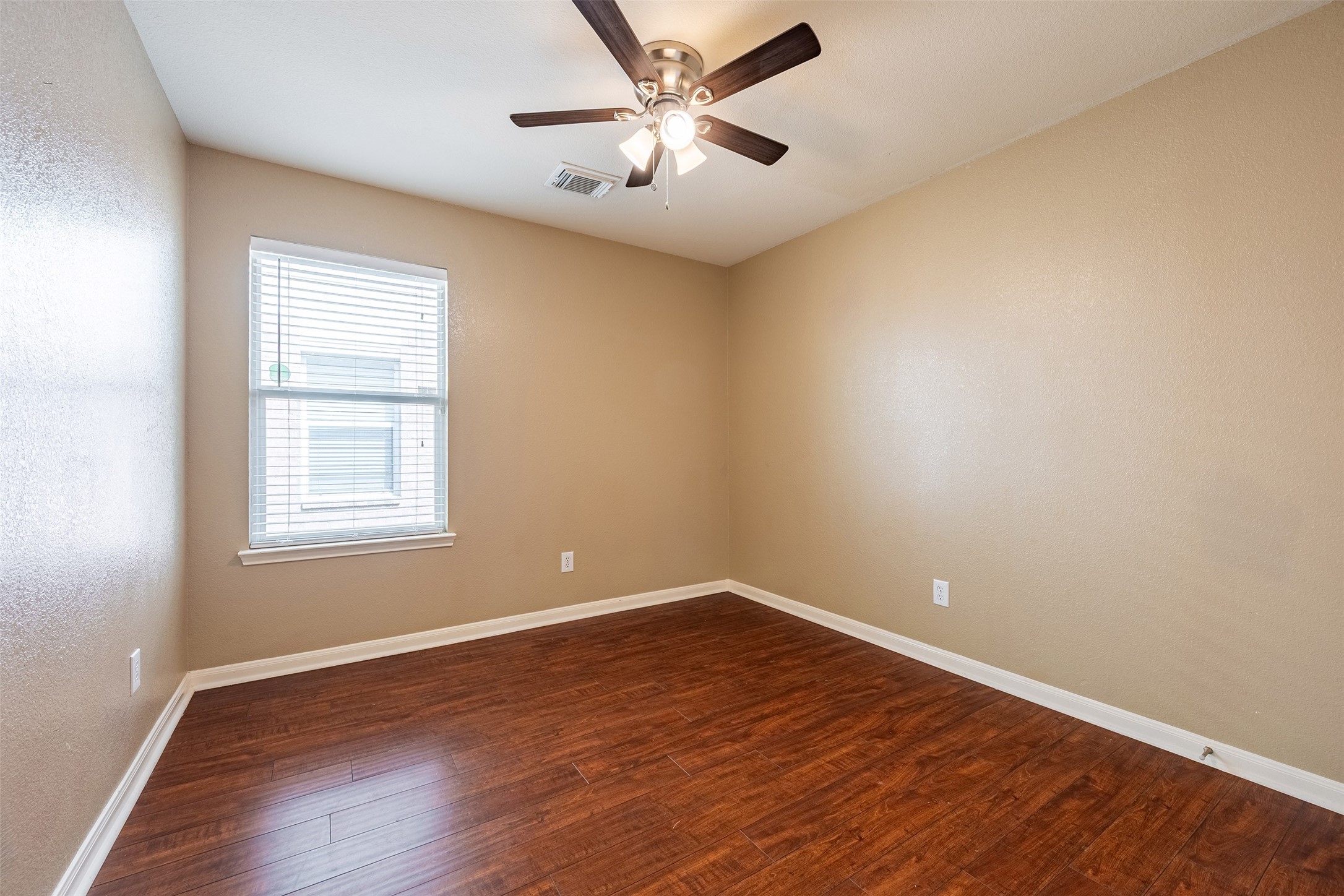 15823 Kings Cypress Lane Cypress, TX 77429 - Photo 22 of 33 Every bedroom provides upgraded comfort and storage! They feature nice and clean laminate floors (no carpet!), a dedicated walk-in closet, and a ceiling fan with lights.