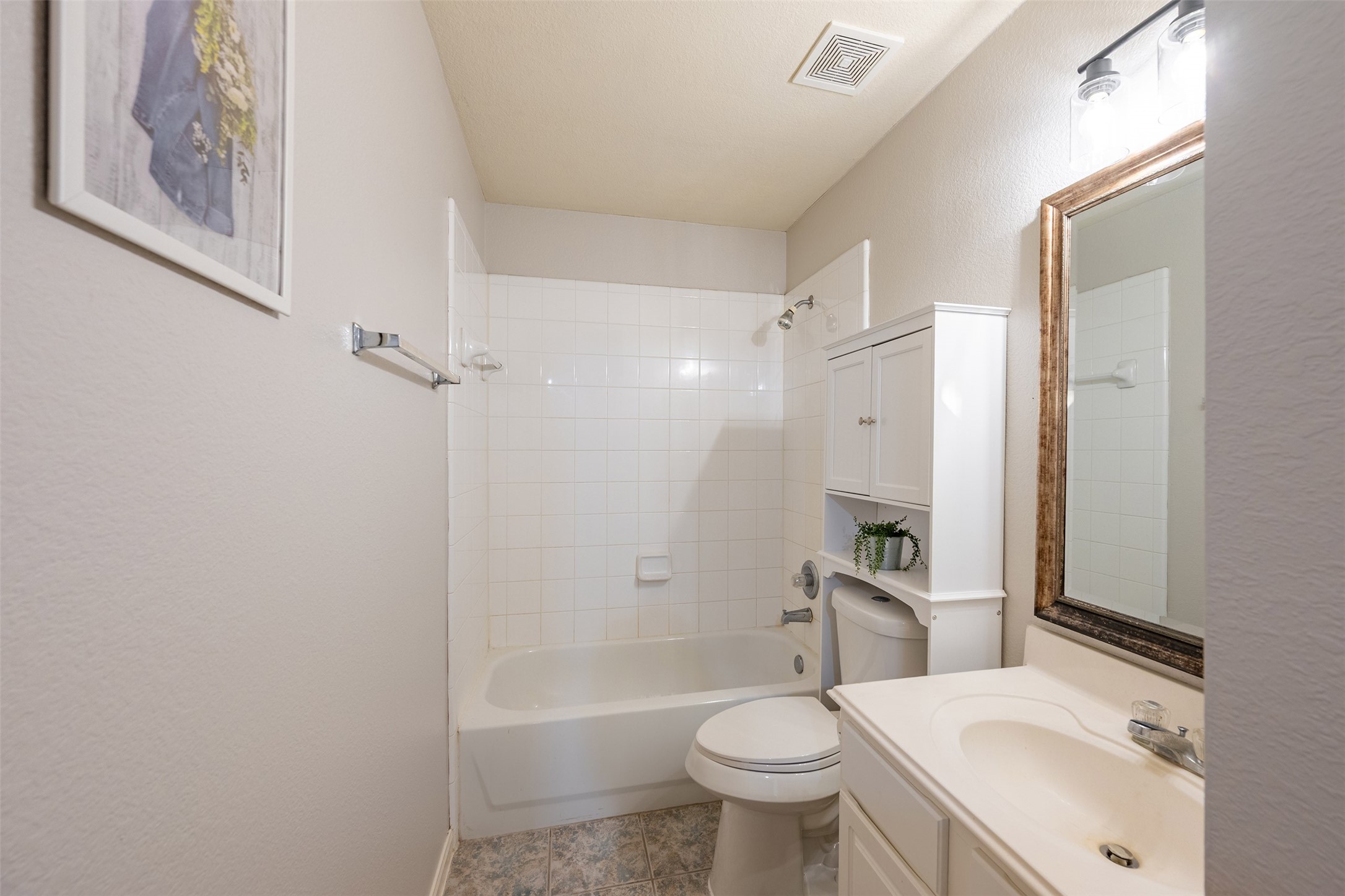 15823 Kings Cypress Lane Cypress, TX 77429 - Photo 25 of 33 Full secondary bathroom featuring a clean tub/shower combo and a convenient extra linen closet, conveniently located near the secondary bedrooms.
