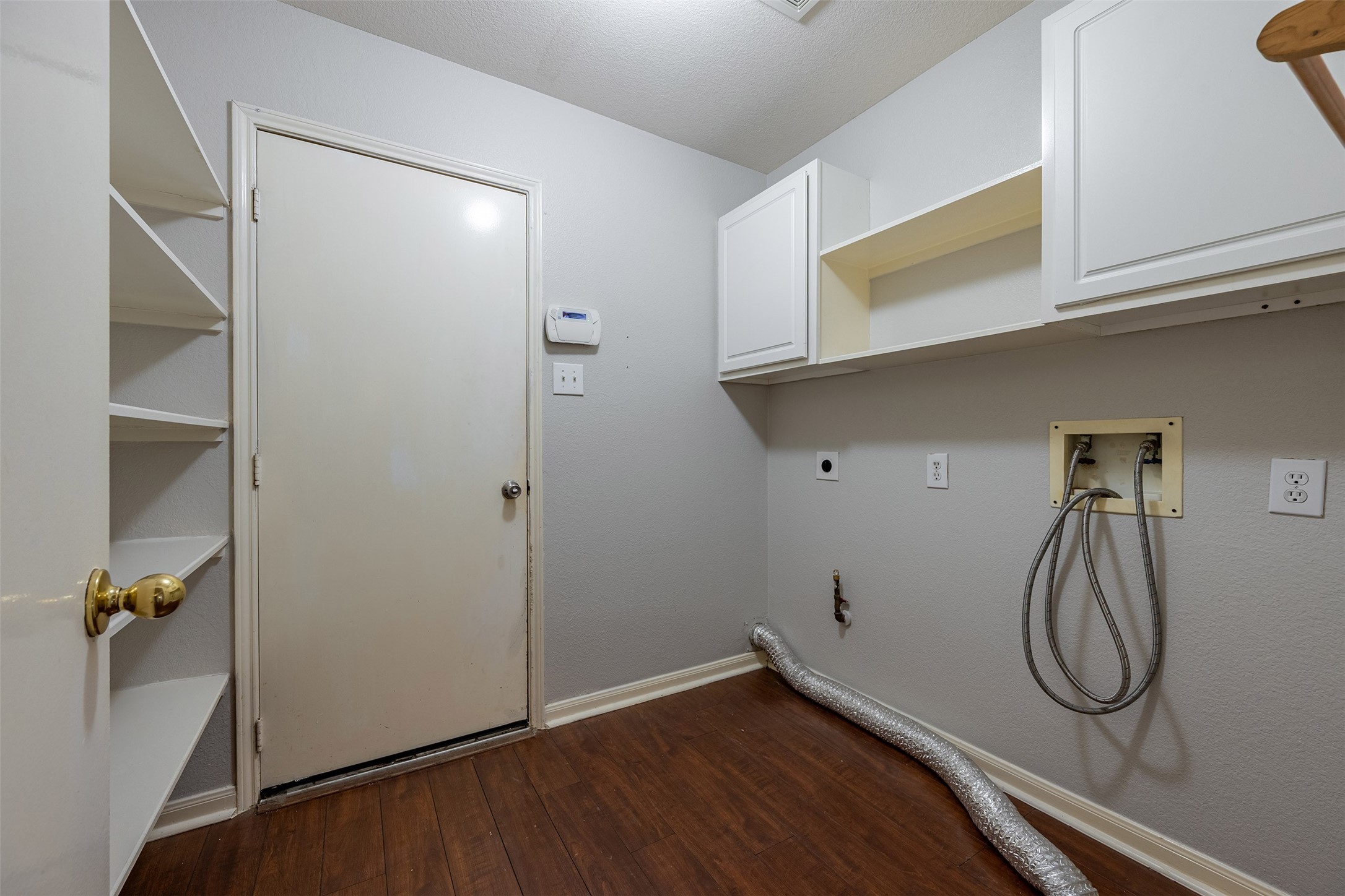 15823 Kings Cypress Lane Cypress, TX 77429 - Photo 31 of 33 Dedicated utility room located inside the home featuring both washer and gas dryer hookups, plus plenty of cabinet space for storing all your supplies.