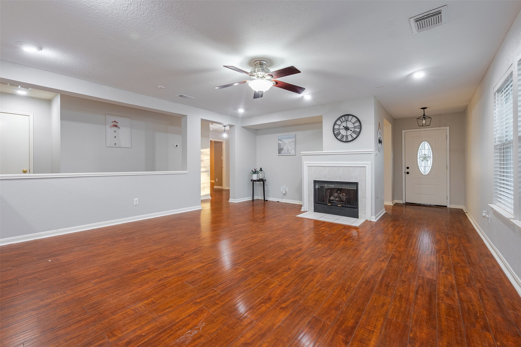 15823 Kings Cypress Lane Cypress, TX 77429 - Photo 7 of 33 Cozy central gas fireplace, perfect for chilly evenings and serving as a beautiful focal point.