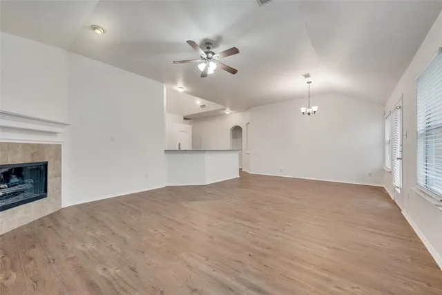 an empty room with fan and windows