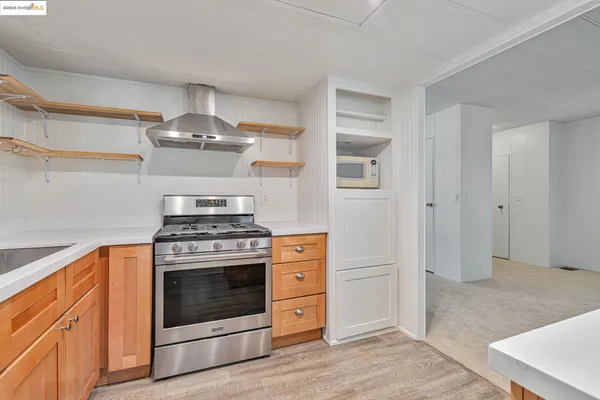 a kitchen with a stove and white cabinets