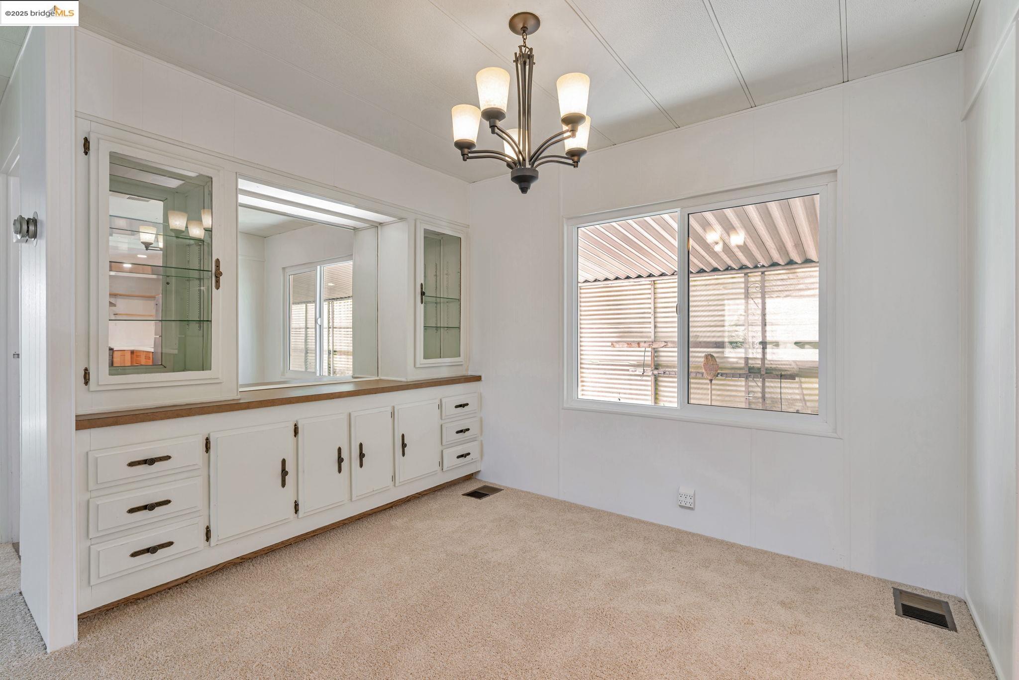 4603 Balfour Road, Unit 58 Brentwood, CA 94513 - Photo 13 of 33 a view of an empty room with chandelier fan and wooden floor