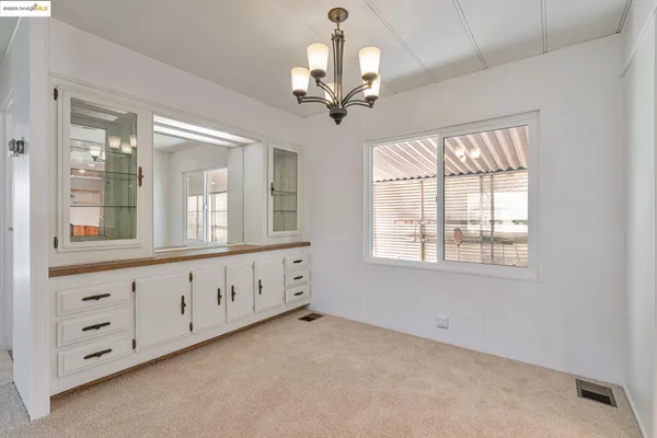an empty room with windows and entrance
