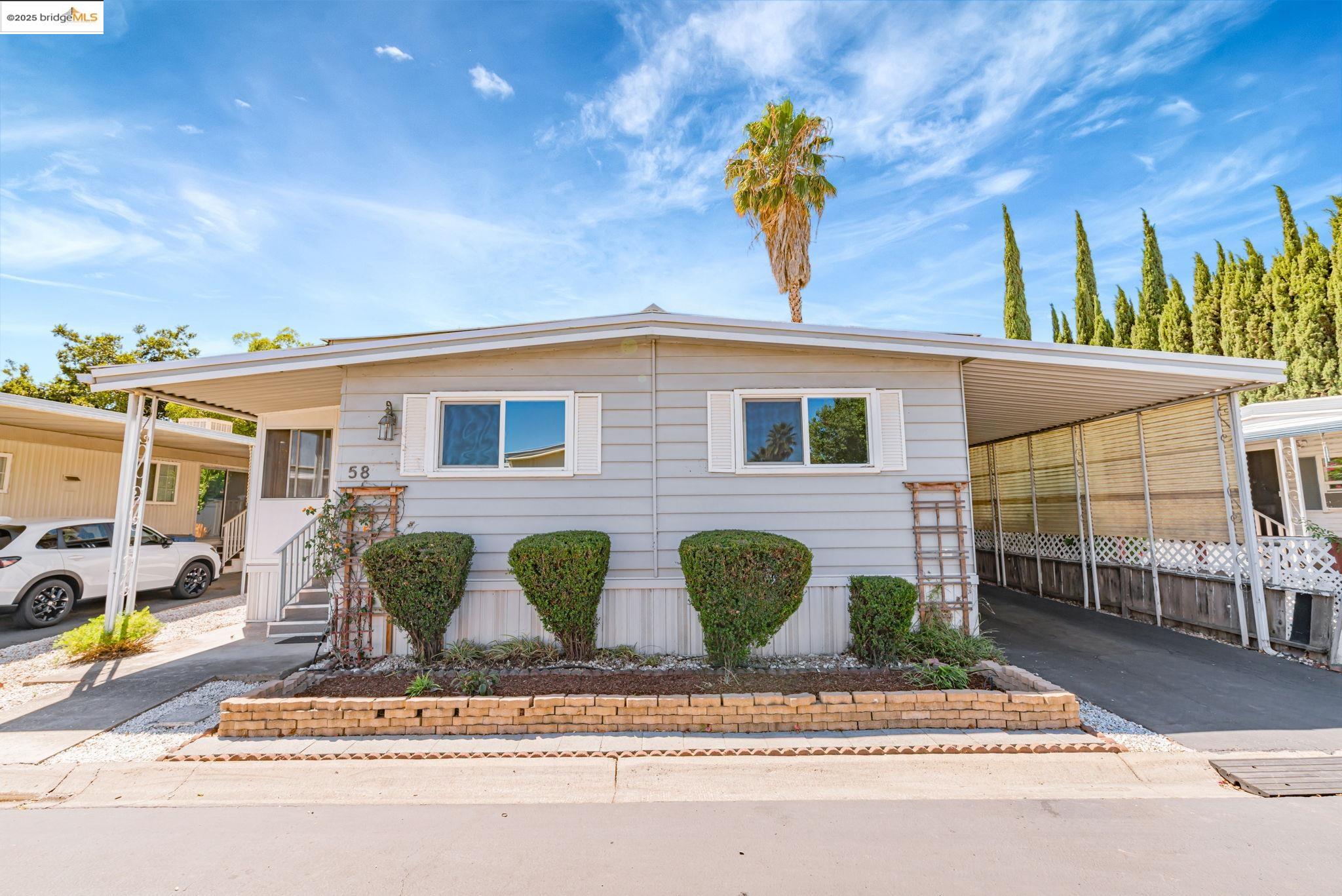 4603 Balfour Road, Unit 58 Brentwood, CA 94513 - Photo 2 of 33 a front view of a house with garden