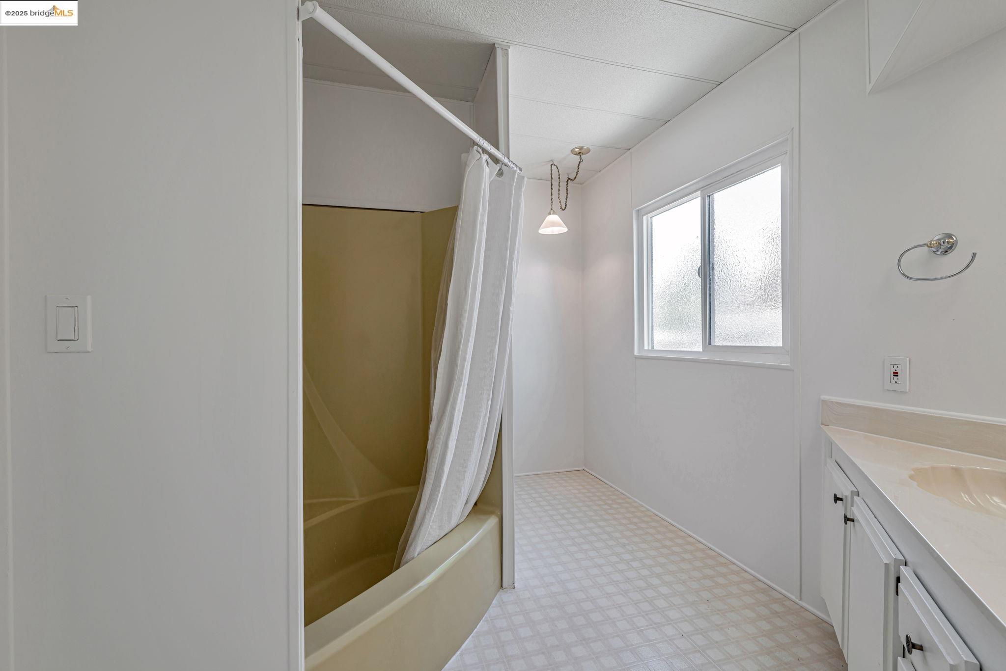 4603 Balfour Road, Unit 58 Brentwood, CA 94513 - Photo 25 of 33 a bathroom with a shower and a sink