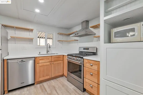 a kitchen with stainless steel appliances granite countertop a stove and a sink
