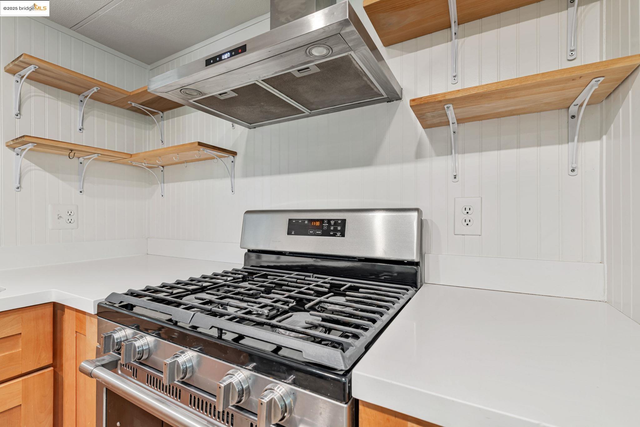 4603 Balfour Road, Unit 58 Brentwood, CA 94513 - Photo 10 of 33 a stove sitting inside of a kitchen with white cabinets
