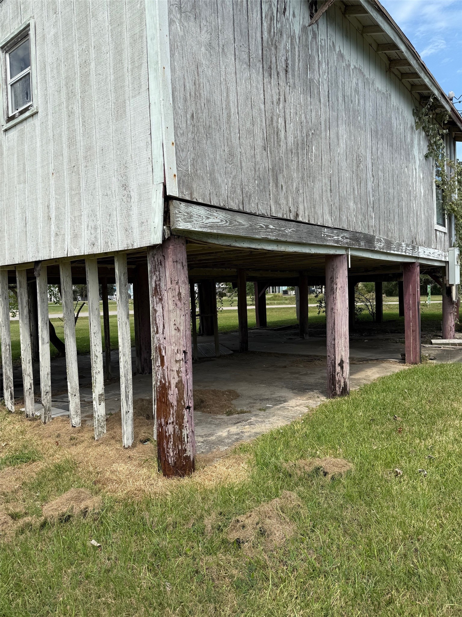 1067 E Road Crystal Beach, TX 77650 - Photo 3 of 4 a front view of a house with garden