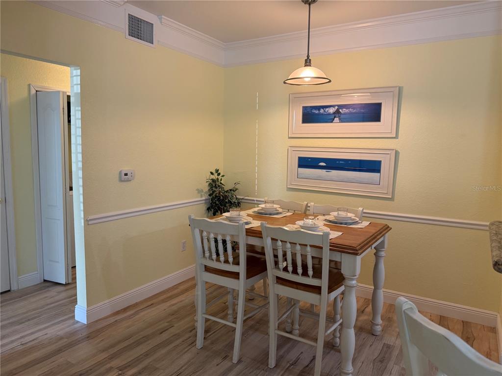 3006 Bonfire Beach Drive, Unit 102 Kissimmee, FL 34746 - Photo 11 of 15 a dining room that has a table and chairs in it