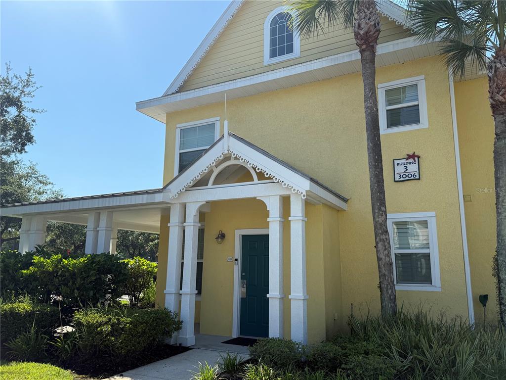 3006 Bonfire Beach Drive, Unit 102 Kissimmee, FL 34746 - Photo 2 of 15 a front view of a house with a yard