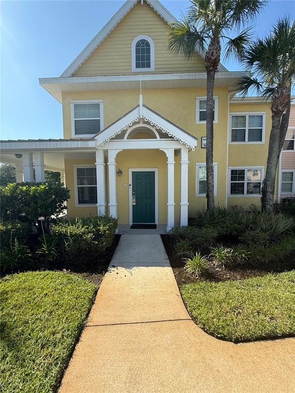3006 Bonfire Beach Drive, Unit 102 Kissimmee, FL 34746 - Photo 4 of 15 a front view of a house with a yard