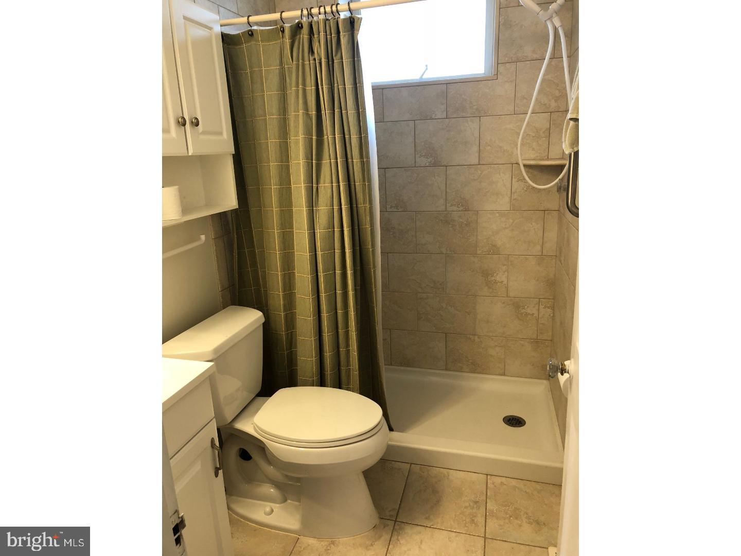 209 Ash Road Wallingford, PA 19086 - Photo 11 of 15 Lower level full bath with tile tub/shower