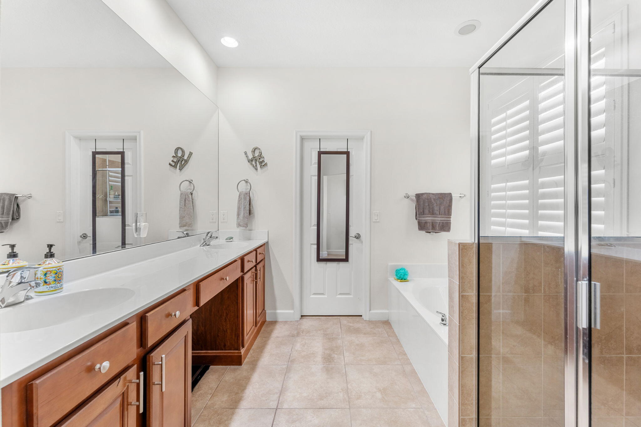 7657 Fieldstone Ranch Square Vero Beach, FL 32967 - Photo 27 of 52 a bathroom with a double vanity sink and mirror