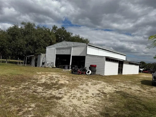 a view of a house with a yard and garage