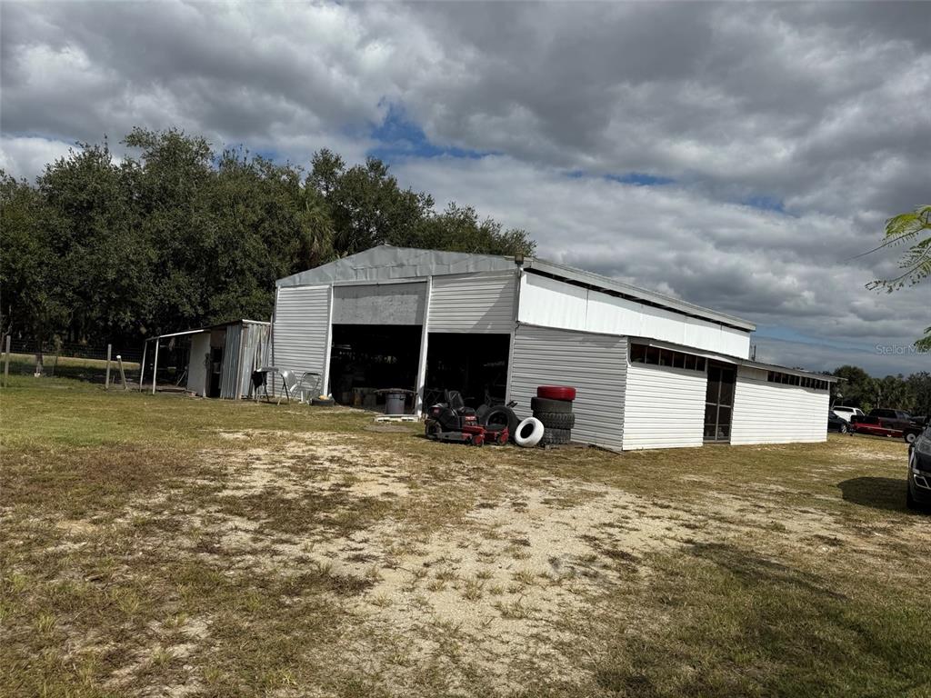 15628 Northwest 310th Street Okeechobee, FL 34972 - Photo 13 of 39 a view of a house with a yard and garage