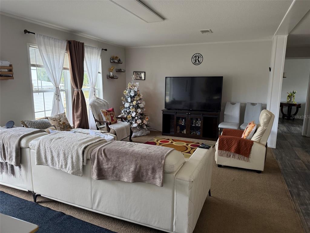 15628 Northwest 310th Street Okeechobee, FL 34972 - Photo 2 of 39 a spacious bedroom with a bed and a flat screen tv