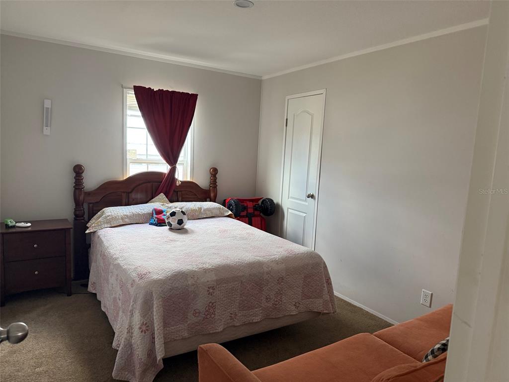 15628 Northwest 310th Street Okeechobee, FL 34972 - Photo 8 of 39 a bedroom with a bed and a window