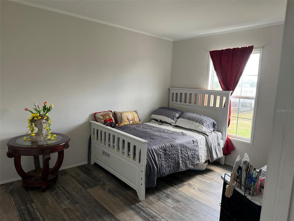 15628 Northwest 310th Street Okeechobee, FL 34972 - Photo 9 of 39 a bedroom with a bed and a window