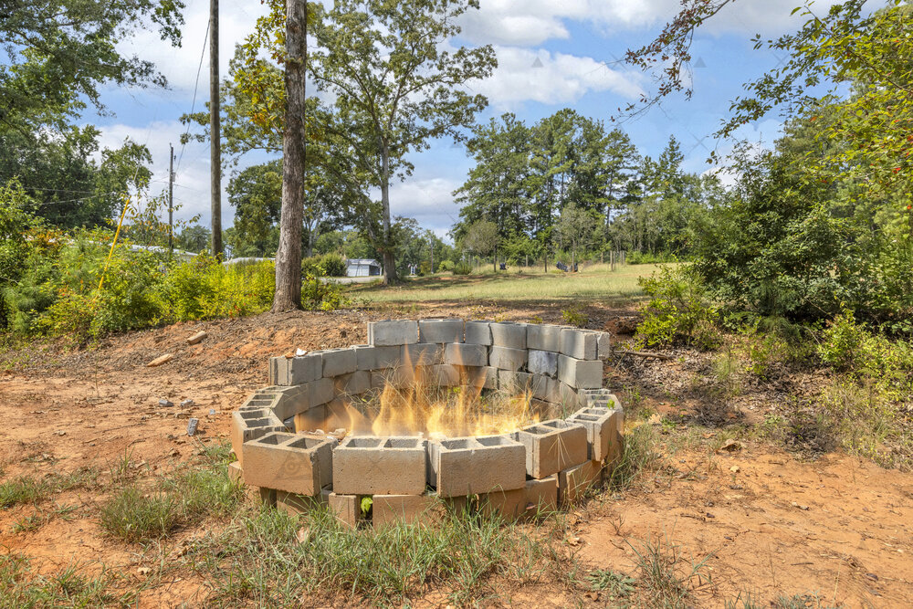 107 Clearwater Shores Road Fair Play, SC 29643 - Photo 15 of 23 A stone fire pit warms this quiet backyard surrounded by mature trees.