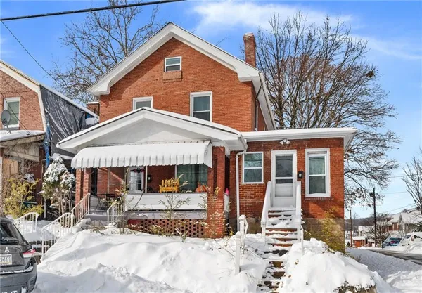 a view of a house with snow on the road