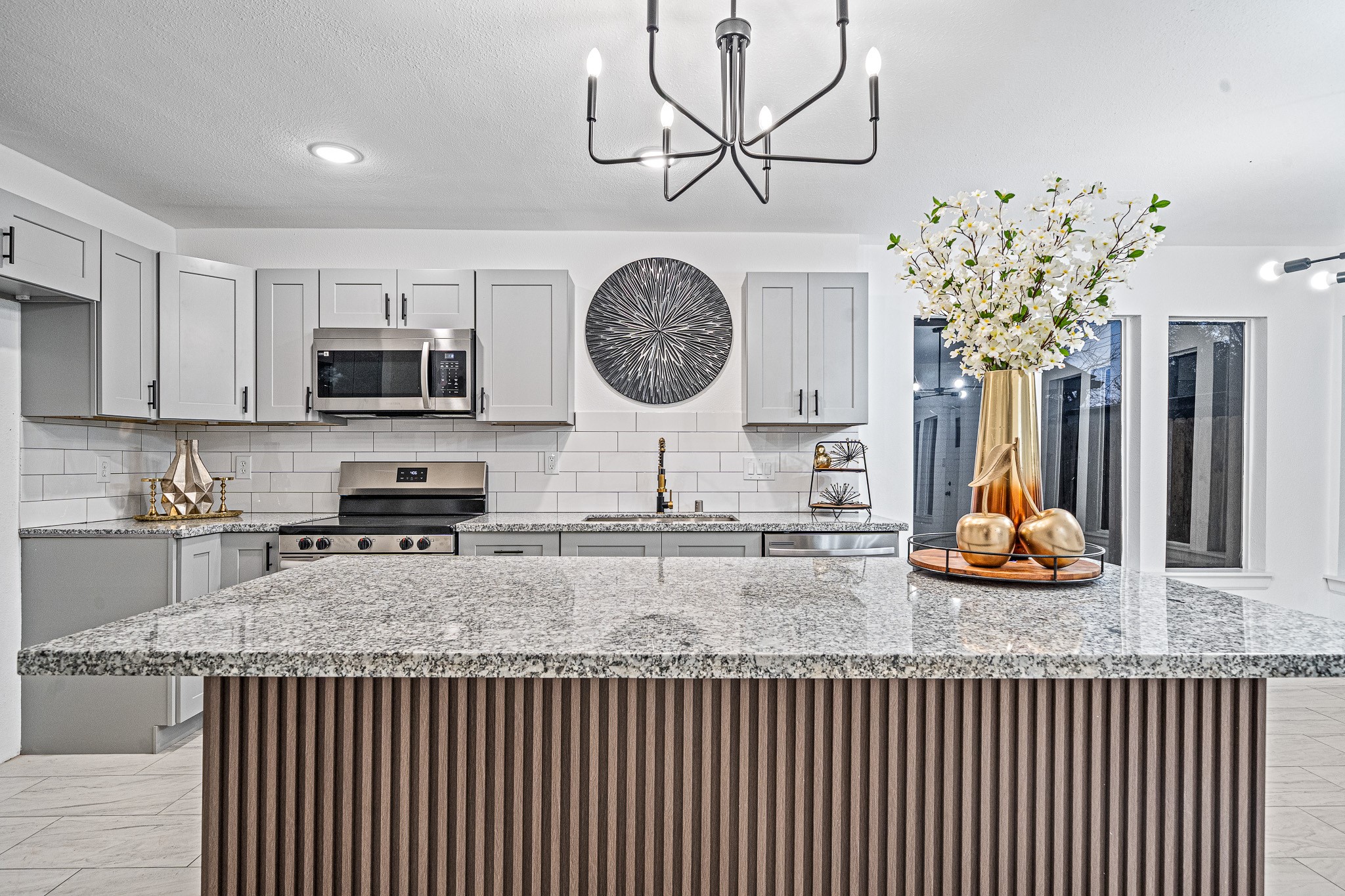 6706 Trigate Drive Houston, TX 77489 - Photo 21 of 40 a kitchen with stainless steel appliances granite countertop a sink a stove top oven a chimney and cabinets