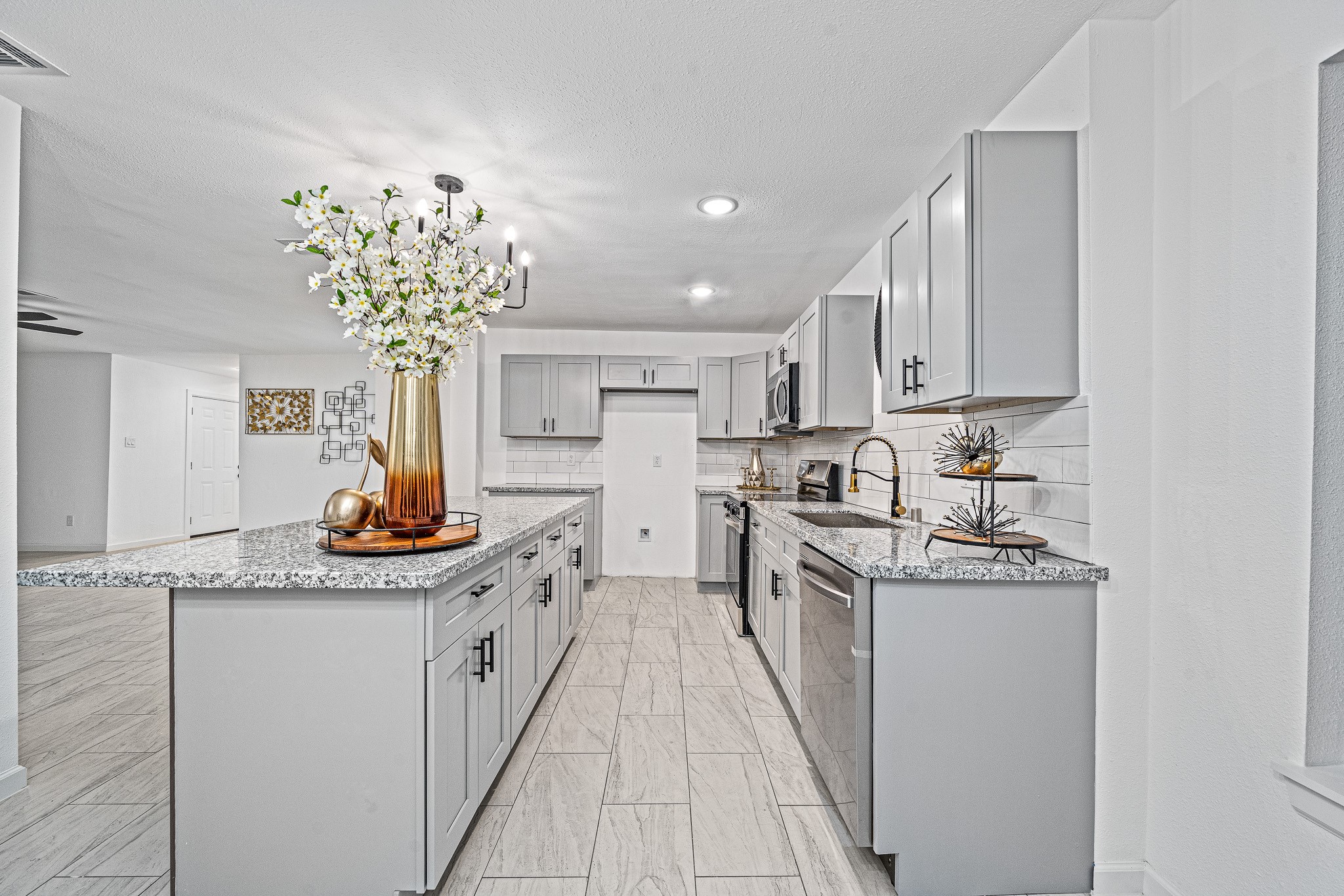 6706 Trigate Drive Houston, TX 77489 - Photo 22 of 40 a kitchen with stainless steel appliances granite countertop a sink and cabinets